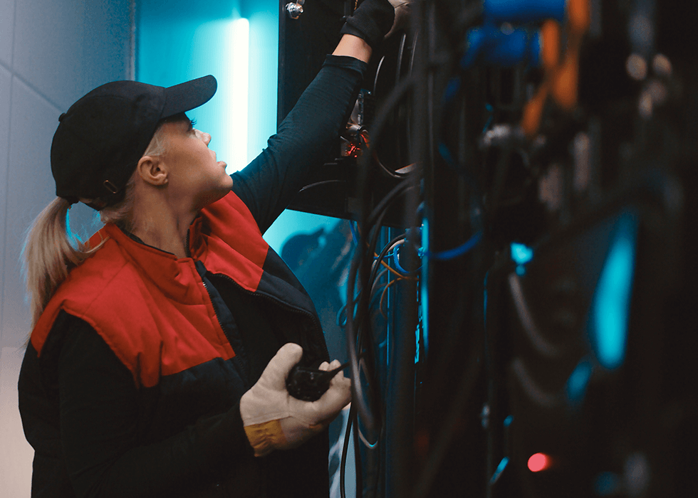 av_technician female av technician speaking on radio and examining wires
