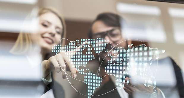 Man and woman looking at digital world display | AVIXA