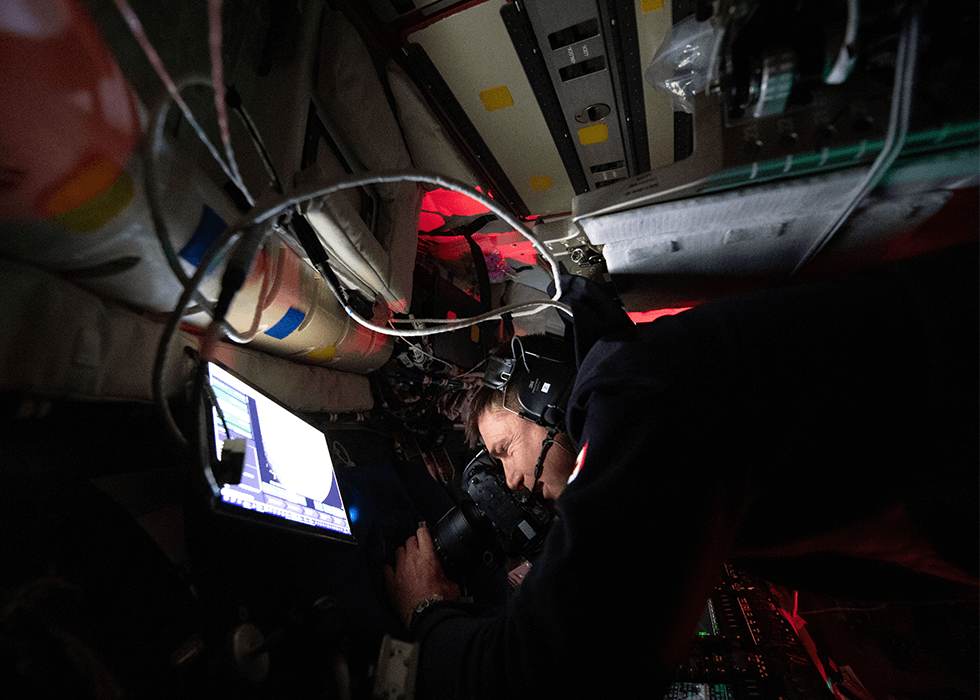 Man using camera on Artemis ii in space