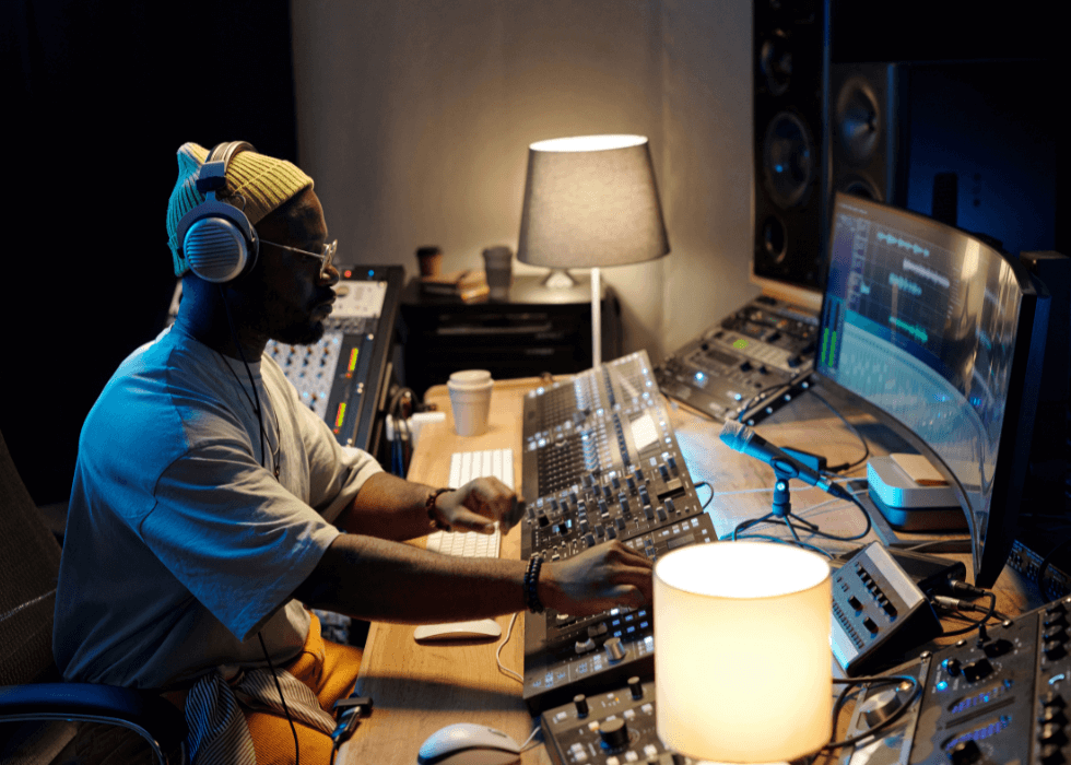 dante_controller Man sitting at mixing console in studio