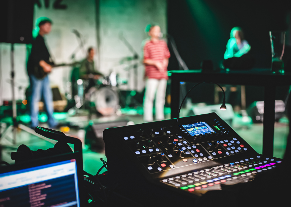 professional audio mixer and lighting panel at a band performance