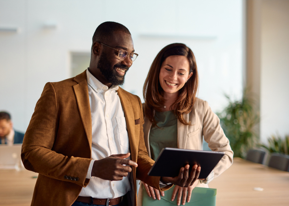 needs_assessment Man and woman looking and smiling at tablet