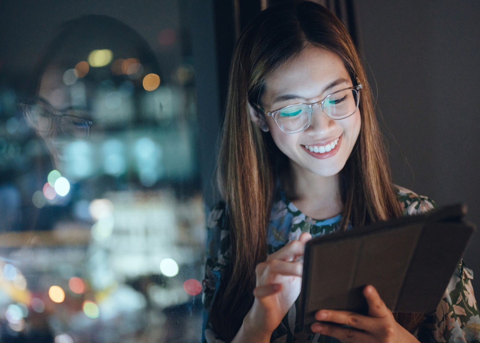 Business woman with glasses holding tablet