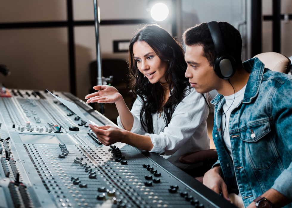 male and female sound engineers at sound board