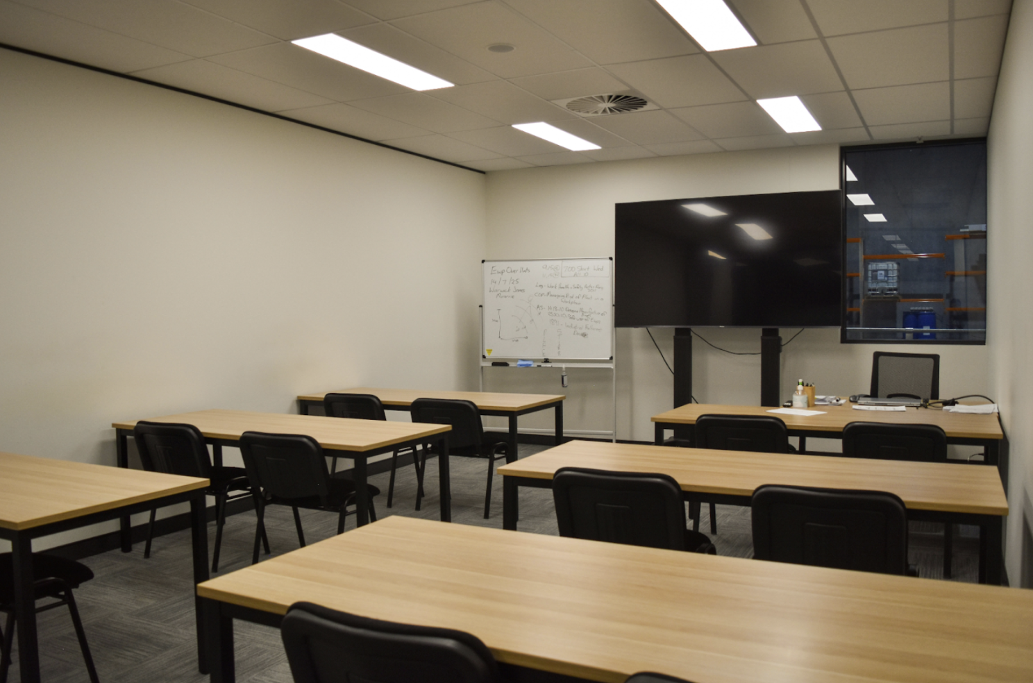 Classroom with desks facing a screen