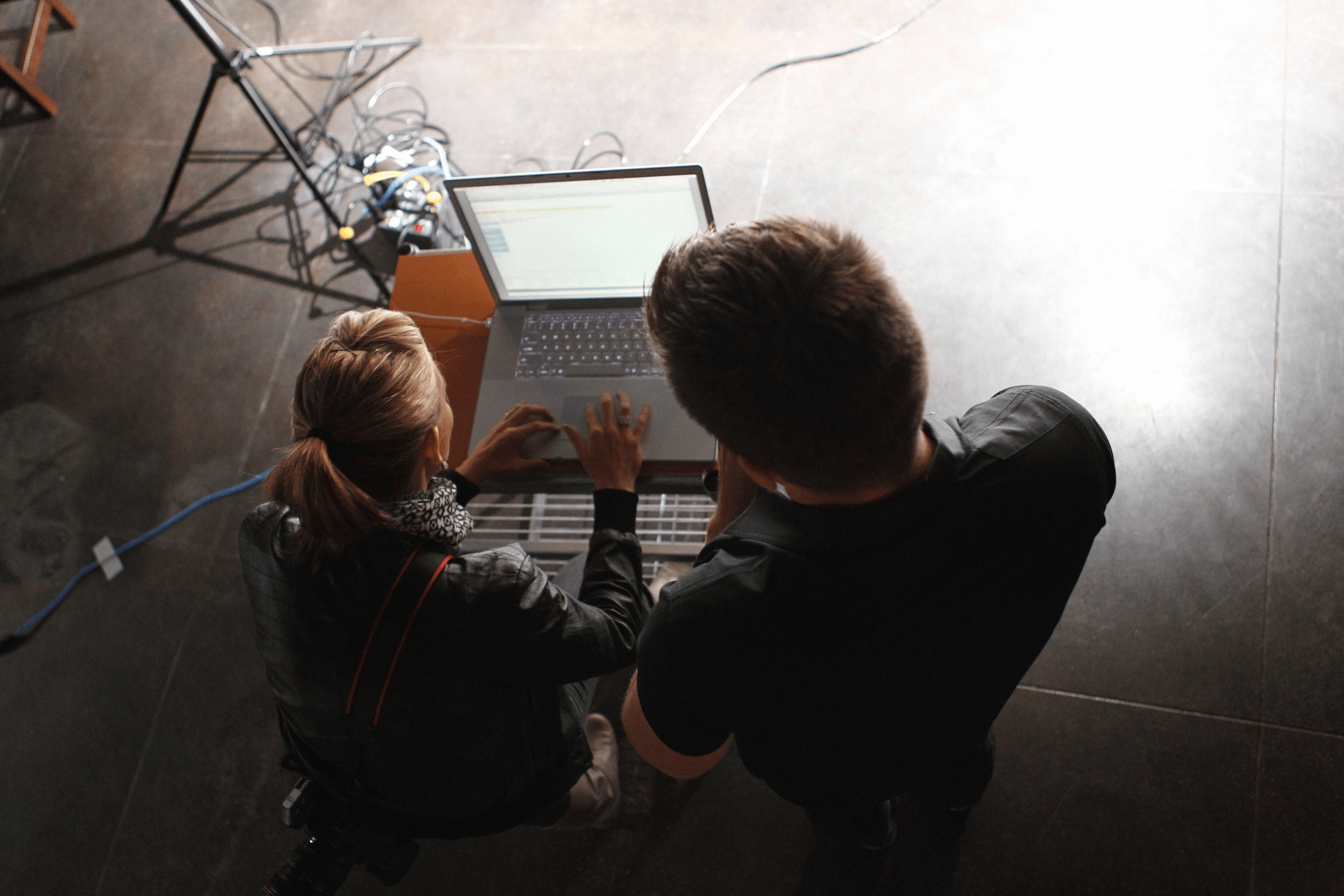 People Working on a Laptop Behind the Scenes on a Film Set