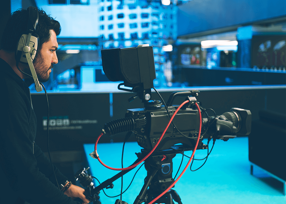 what_is_AVB Video camera operator working with his equipment at indoor event