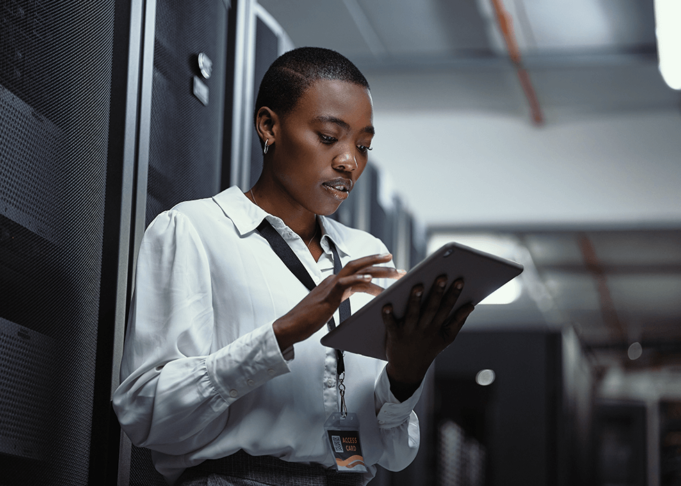 av_support Woman using an ipad in a server room