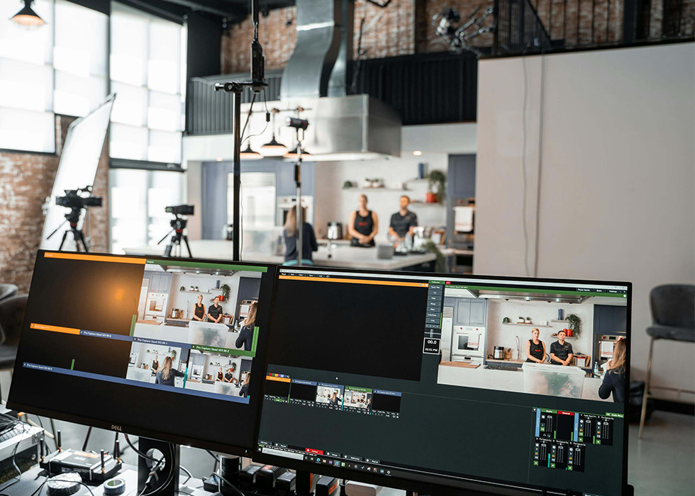 Images of Women and Man on Screens in Photo Studio