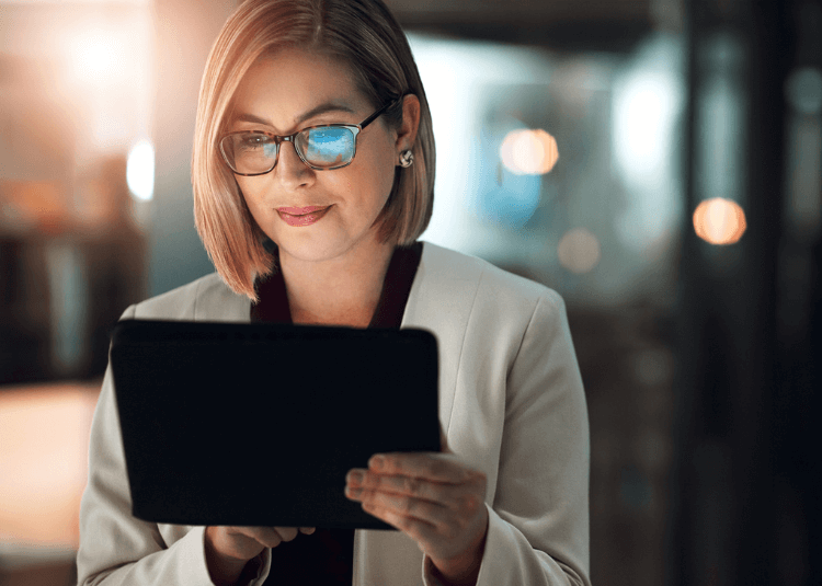 Woman with glasses on a tablet