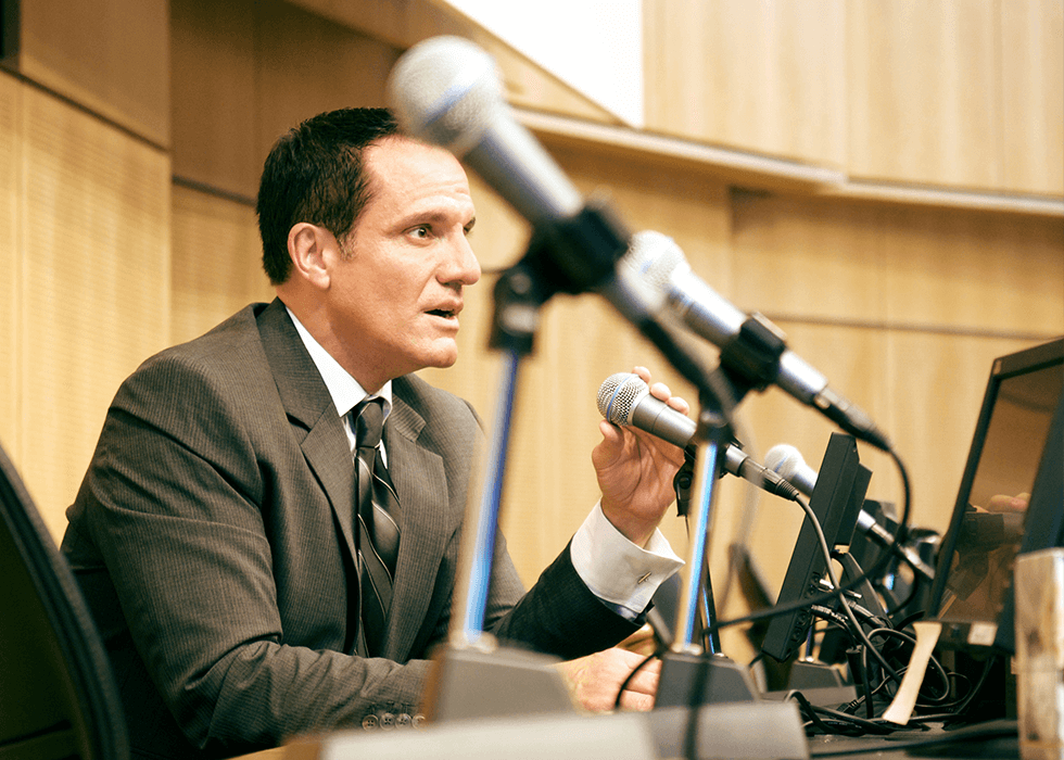 A politician speaking into a microphone
