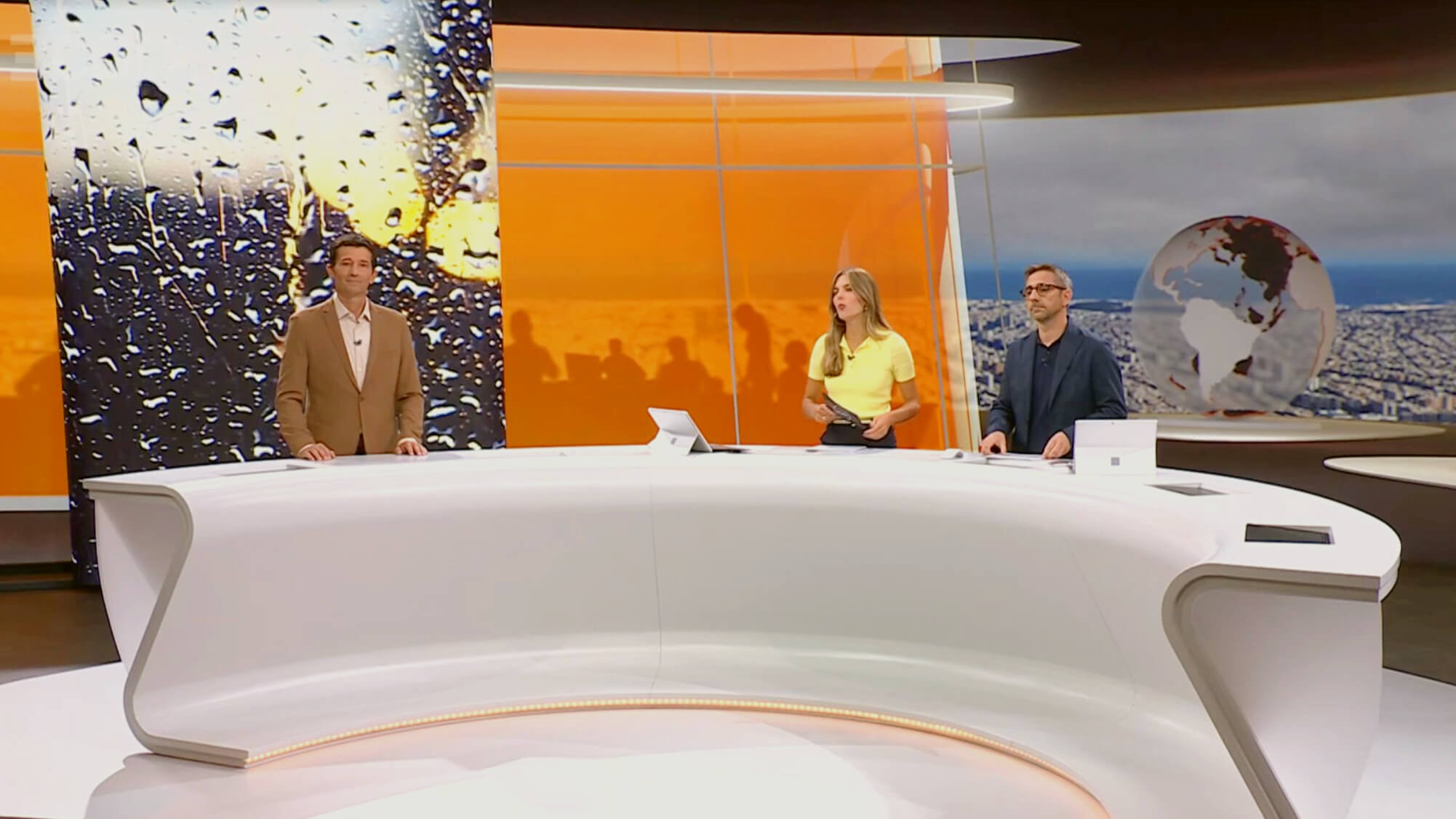 Newscasters sitting at desk at Studio 4