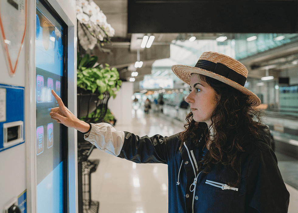 digital_signage_plasma_screen Woman looking at digital sign in airport