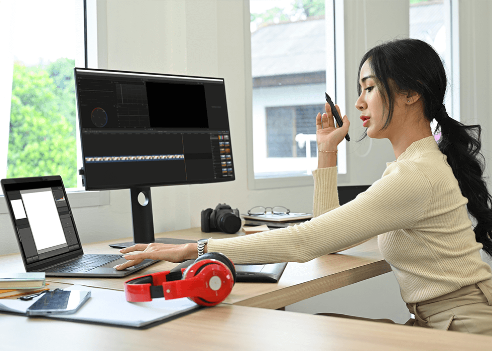 Woman on computer working on video
