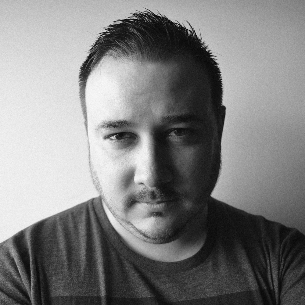 A headshot of writer Alex James Kane